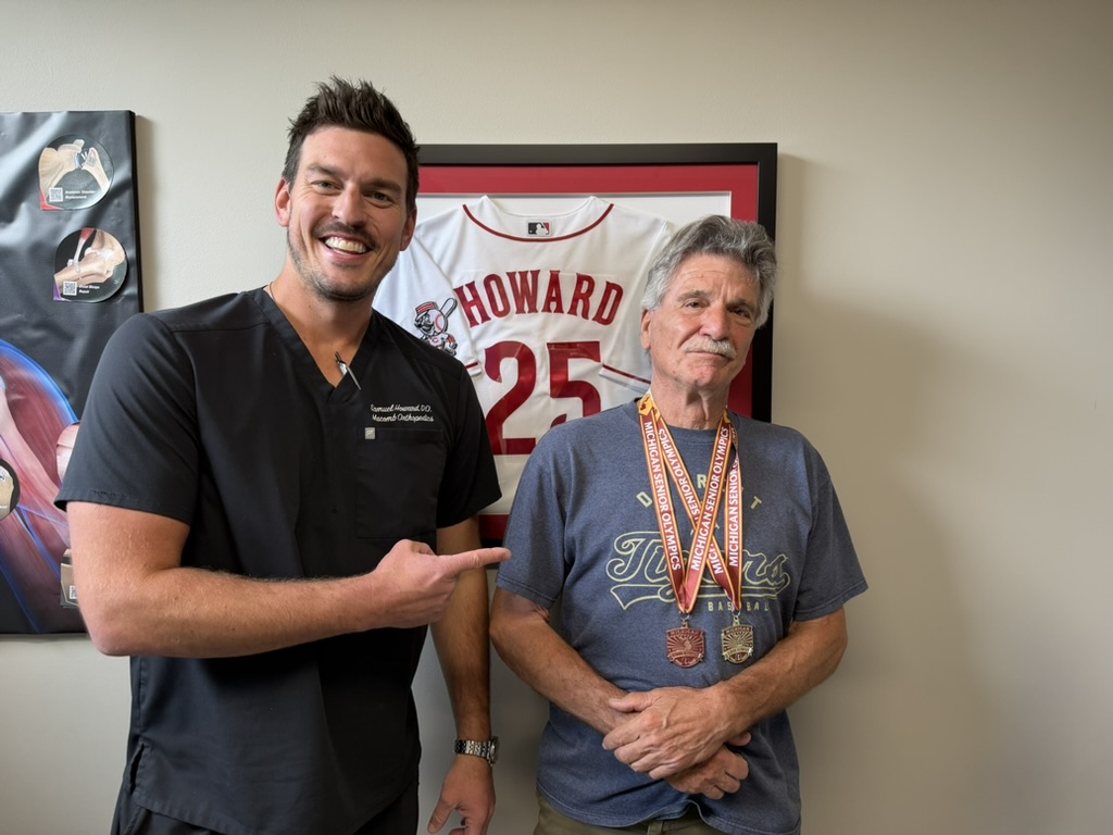 Dr. Howard with a Michigan Senior Olympics athlete in clinic